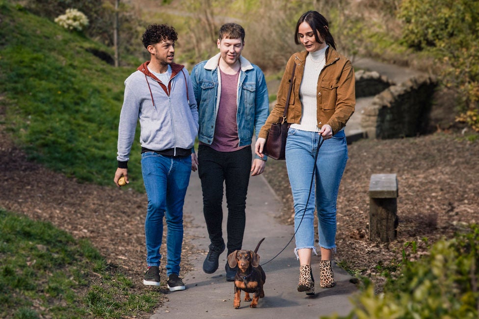 a group of friends walking through the park