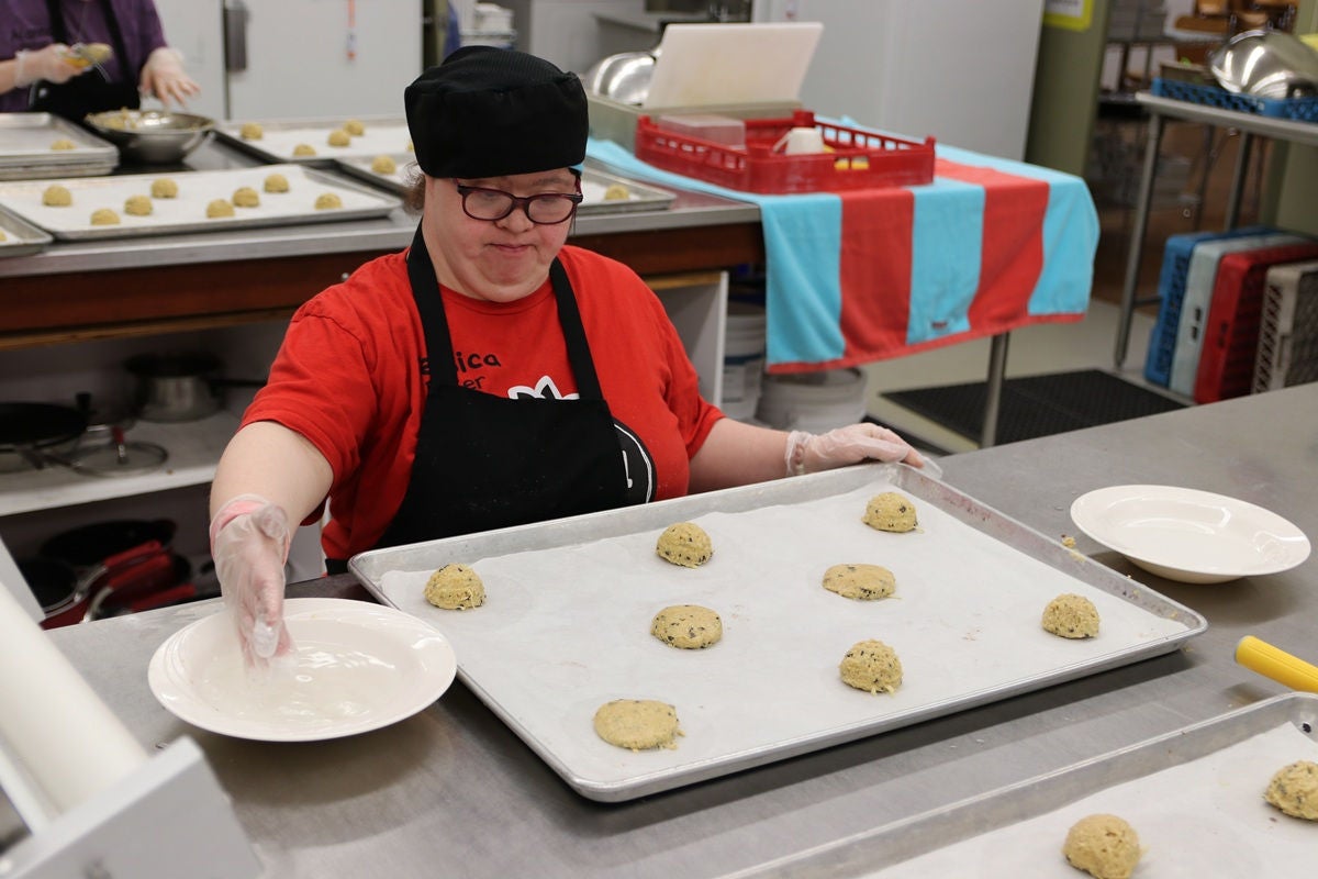 volunteer helping make cookies