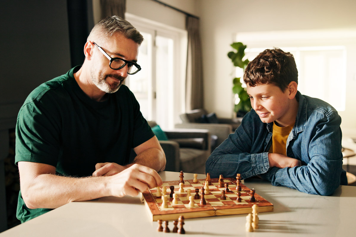 Father and son playing a game of chess