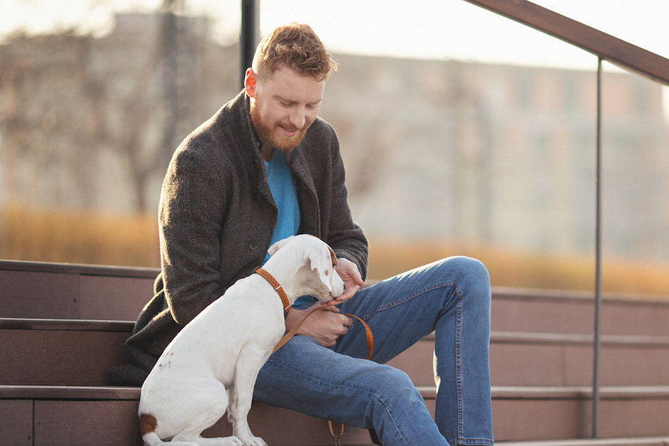 A man sitting on outdoor steps with his dog